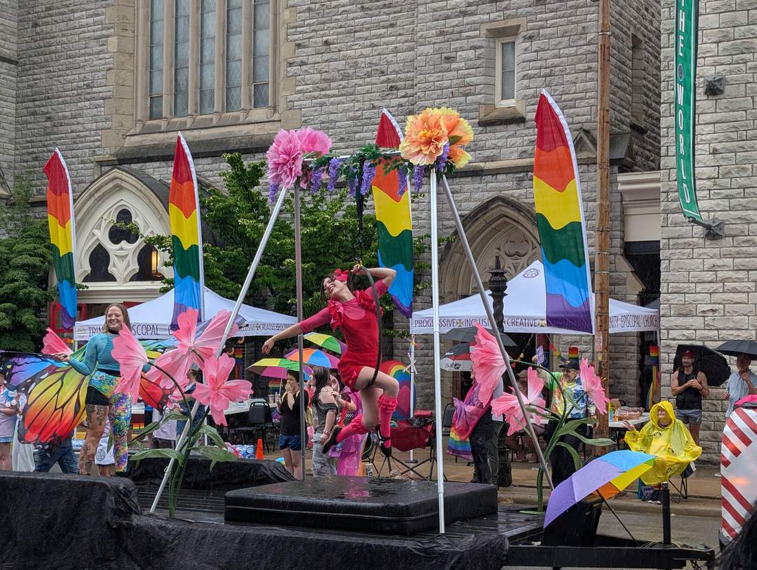 12:22 P.M. — THE AERIALIST, IN THE RAIN, OUTSIDE TRINITY EPISCOPAL